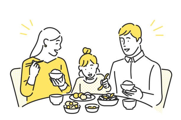Eating dinner around the table in a family gathering. Eating dinner around the table in a family gathering.